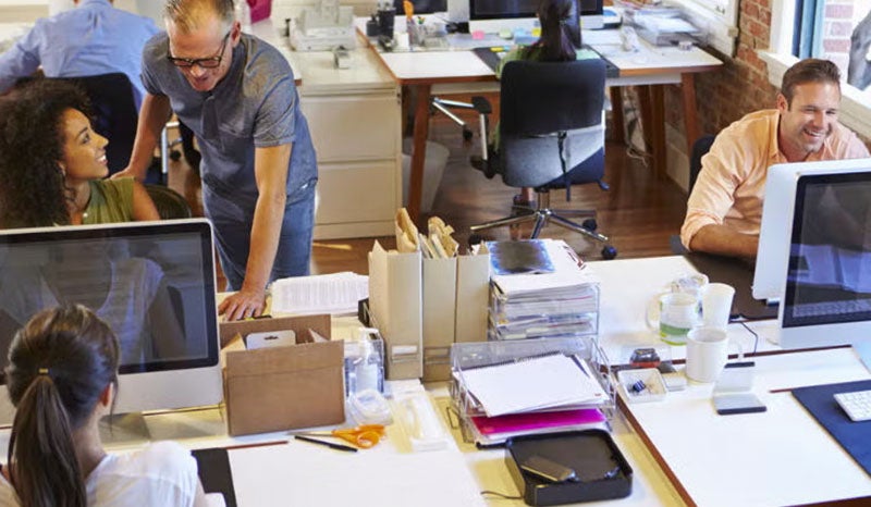 A group of professionals working in a modern office with a clear focus on collaboration.
